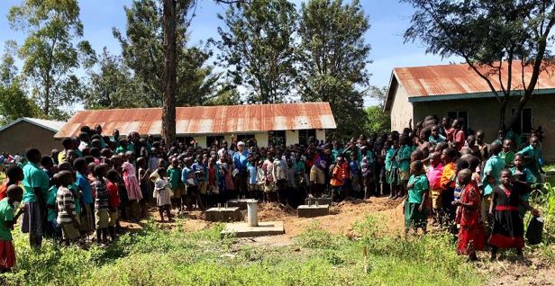 Schoolchildren gather at the new well sitePoyemi