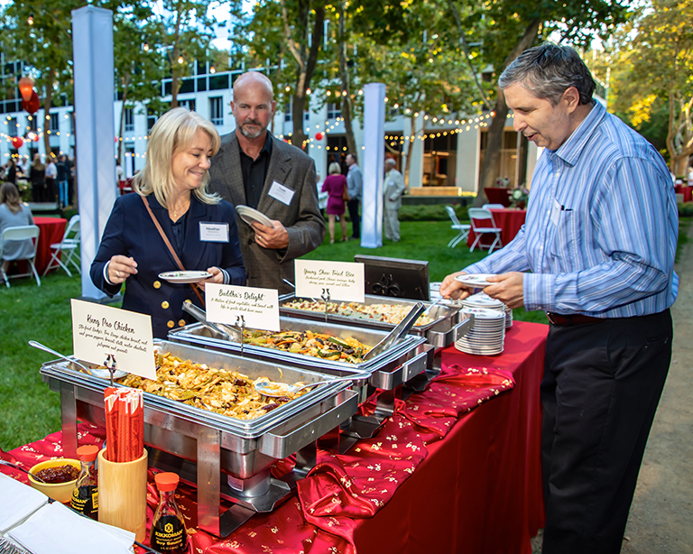 Reeve-Knight Construction’s Kerry Bal and Todd Swanson, and Heather Swanson of Ameriprise Financial, enjoy the feast prepared by Fat Family Restaurants