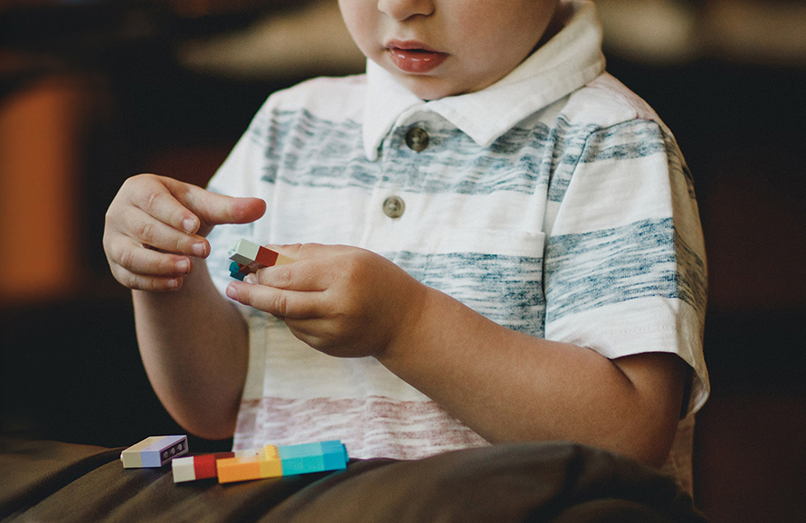 Toddler playing with LEGO blocks