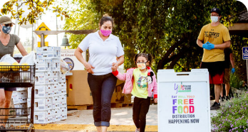 Mother and daughter at the Yolo Food Bank distribution center