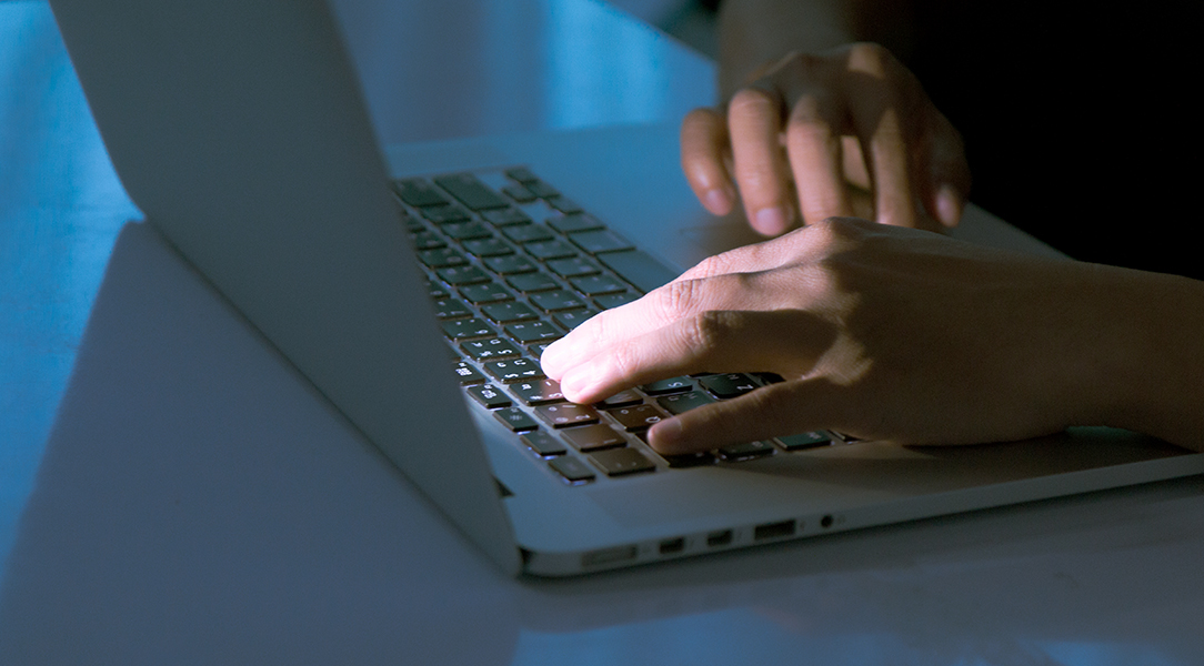 Close up of hands typing on laptop