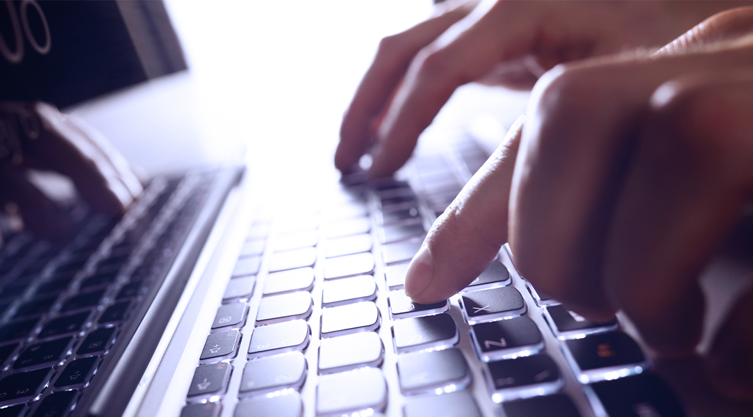 Close up of person typing on laptop